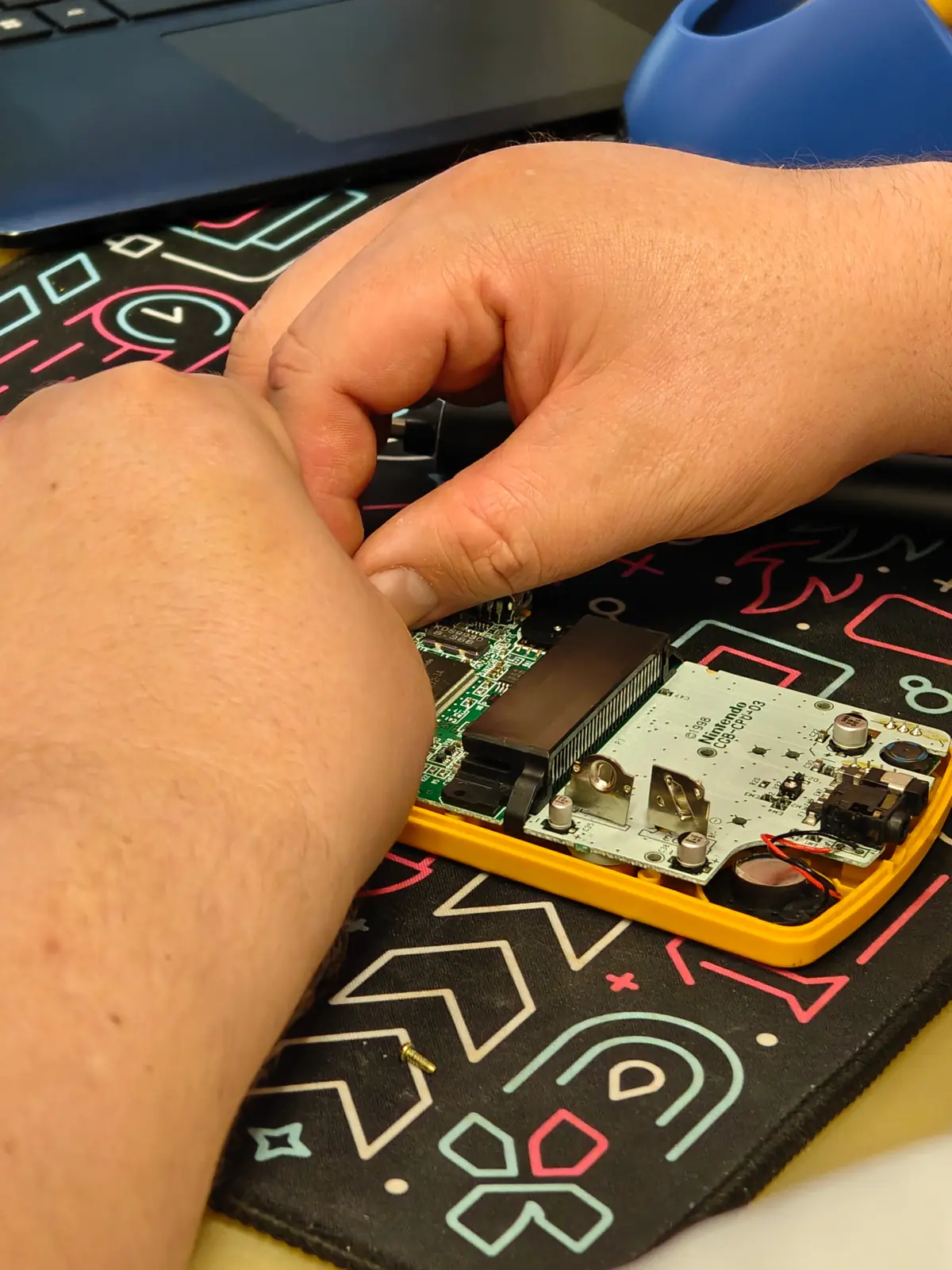 Handheld game console being repaired at Aura Tech